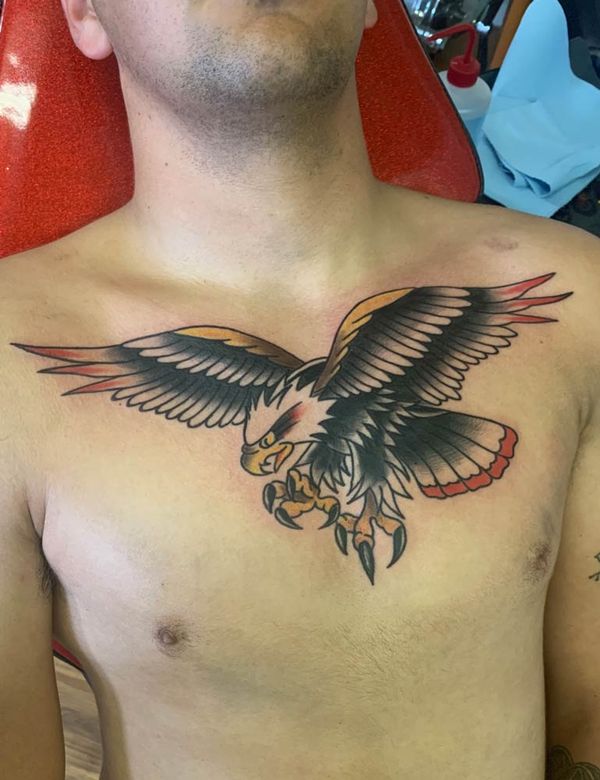 A man has a tattoo of an eagle on his chest.