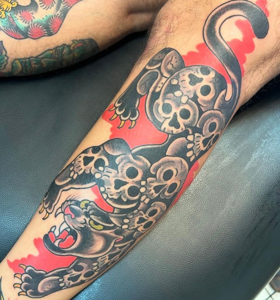 Puma with a skeleton print tattoo on a leg