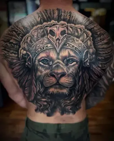 Realistic lion back tattoo with feathered warrior headdress in black and grey style