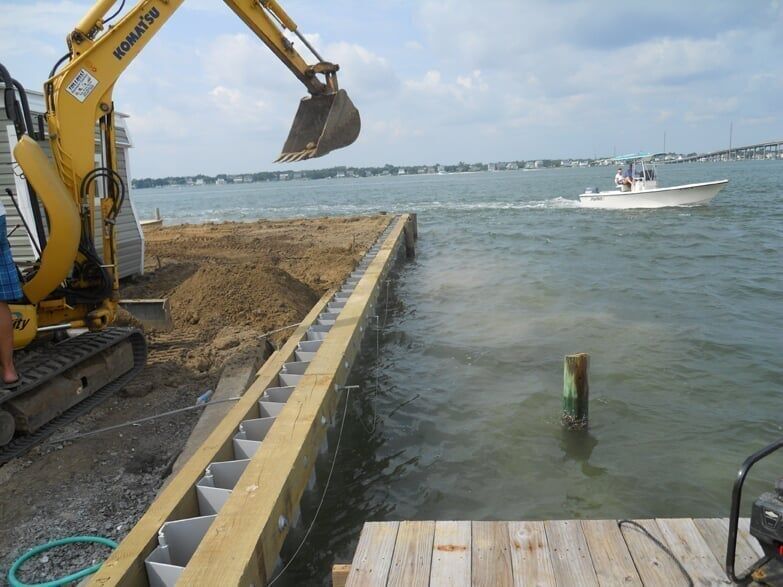 Equipment digging beside wall