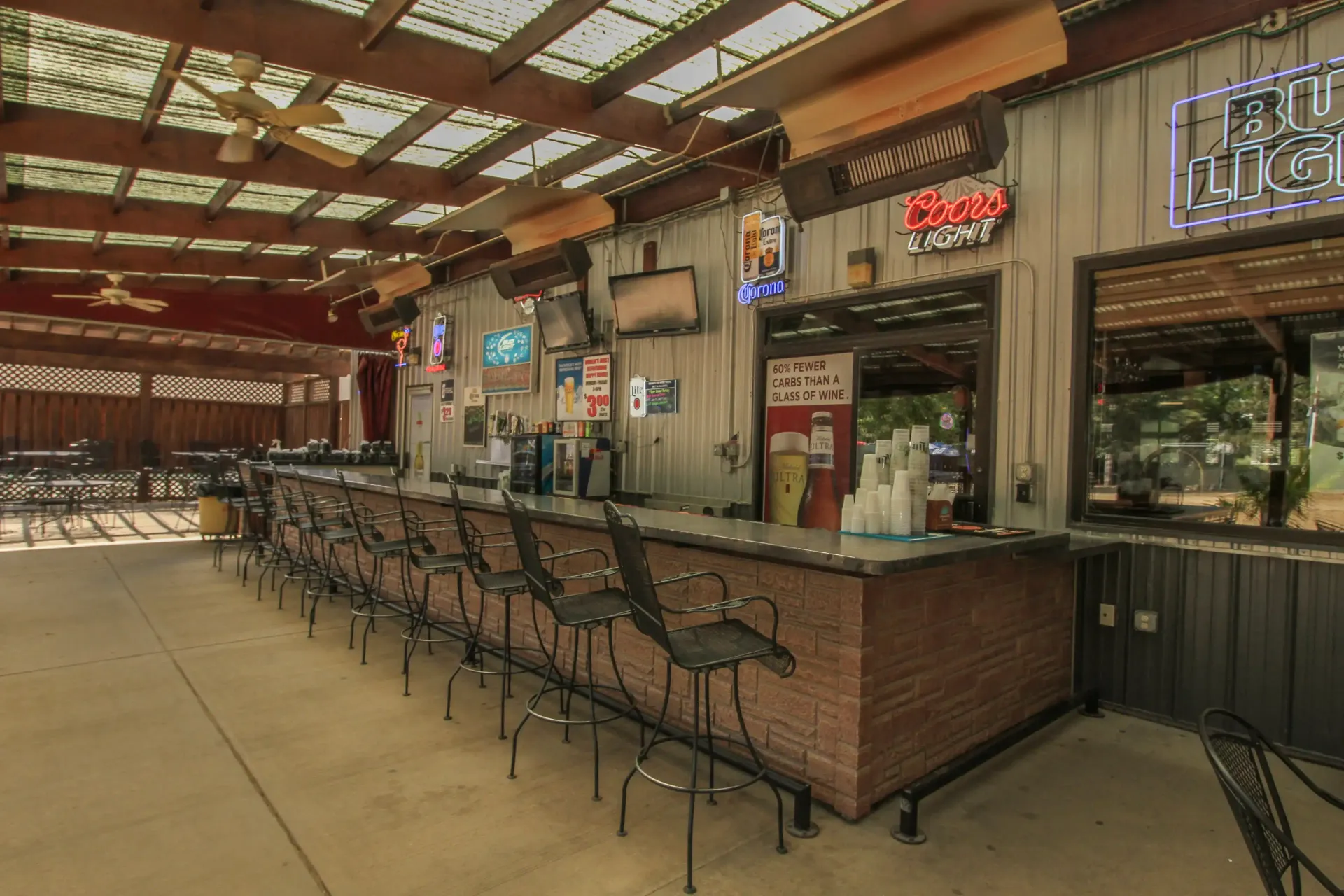 A long bar with a lot of stools in a restaurant.