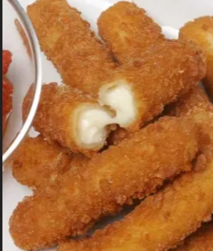 A plate of fried cheese sticks next to a bowl of tomato sauce