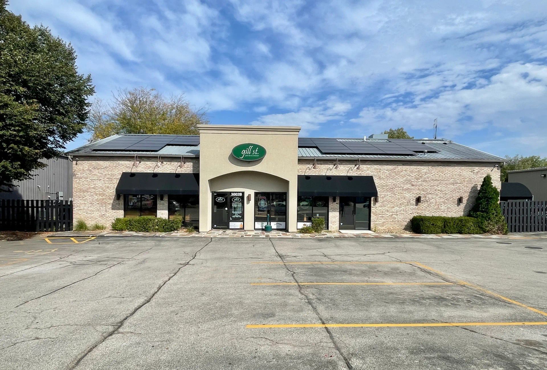 A large brick building with a parking lot in front of it.