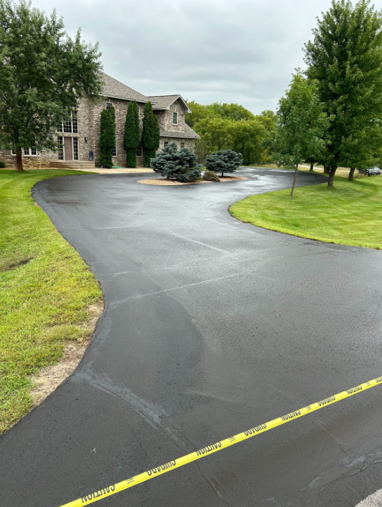 A large house with a large driveway leading to it