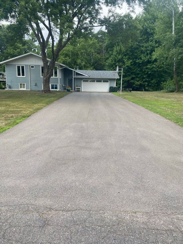 A driveway leading to a house with a garage