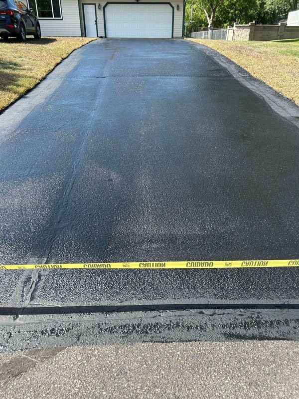 A car is parked in the driveway of a house.