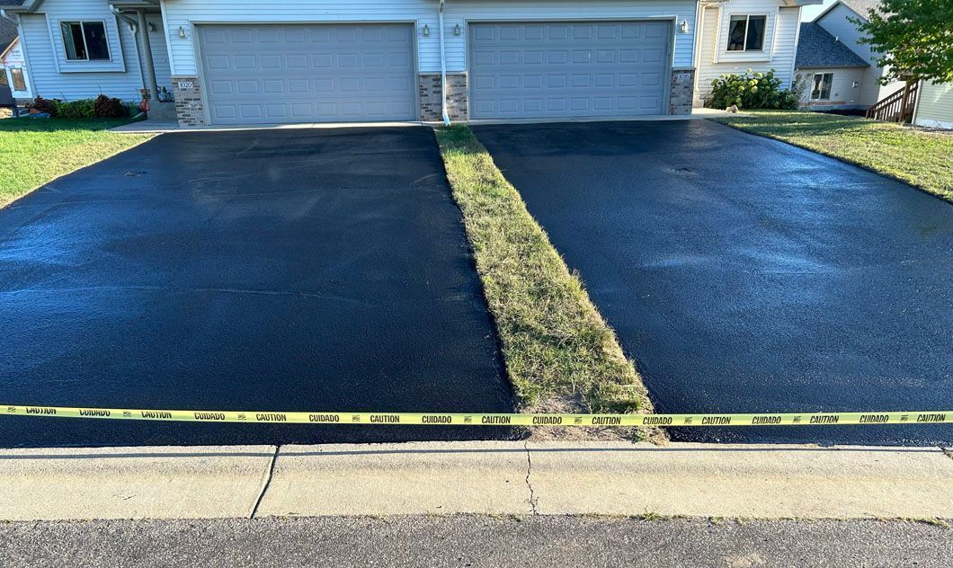 A driveway that has been paved in front of a house.