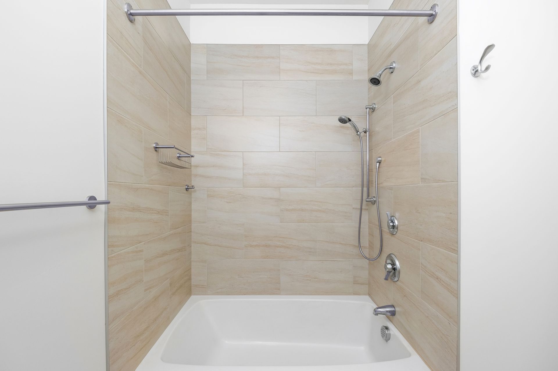 A bathroom with a bathtub and a shower.