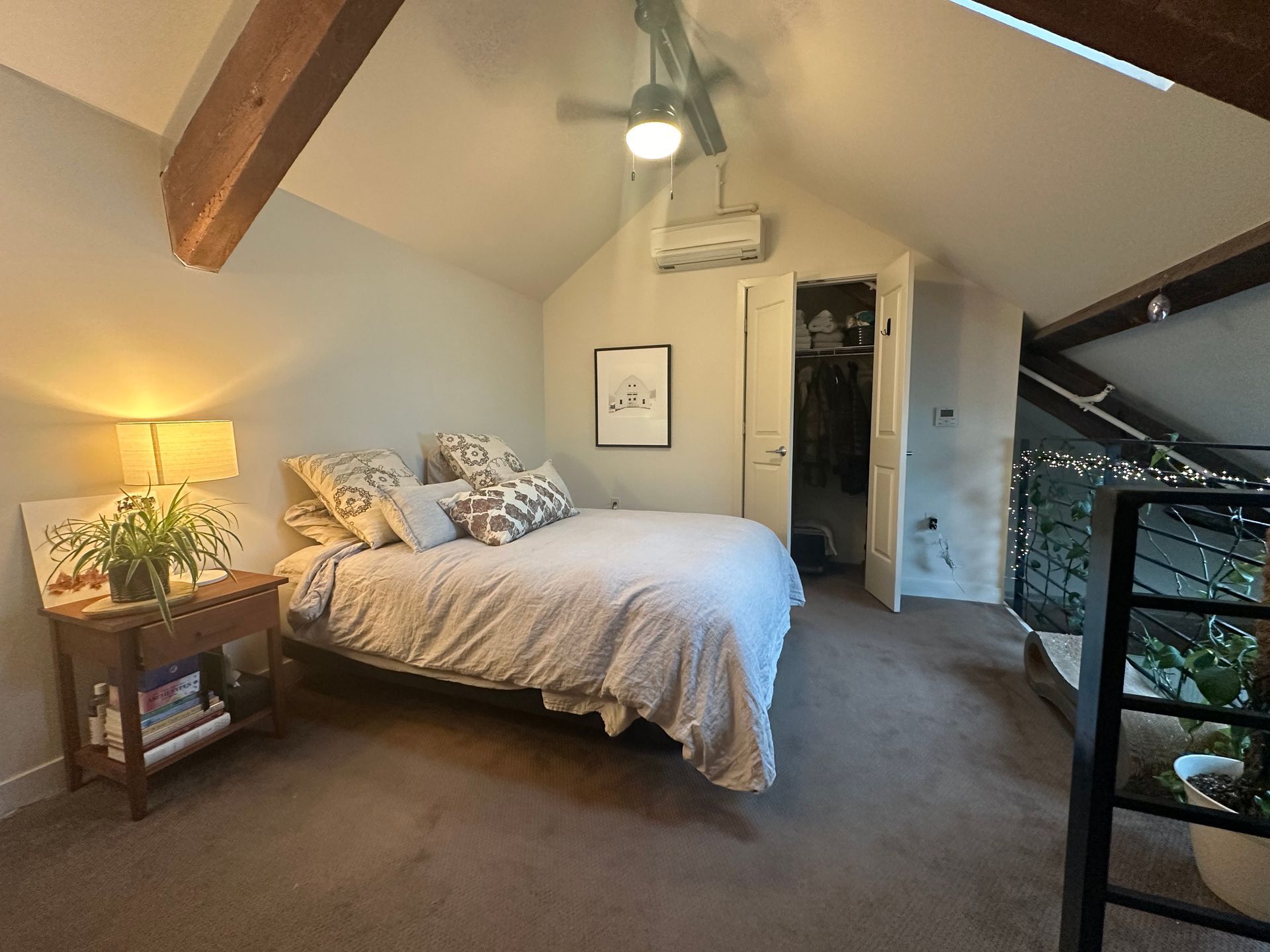 A bedroom with a bed and a ceiling fan