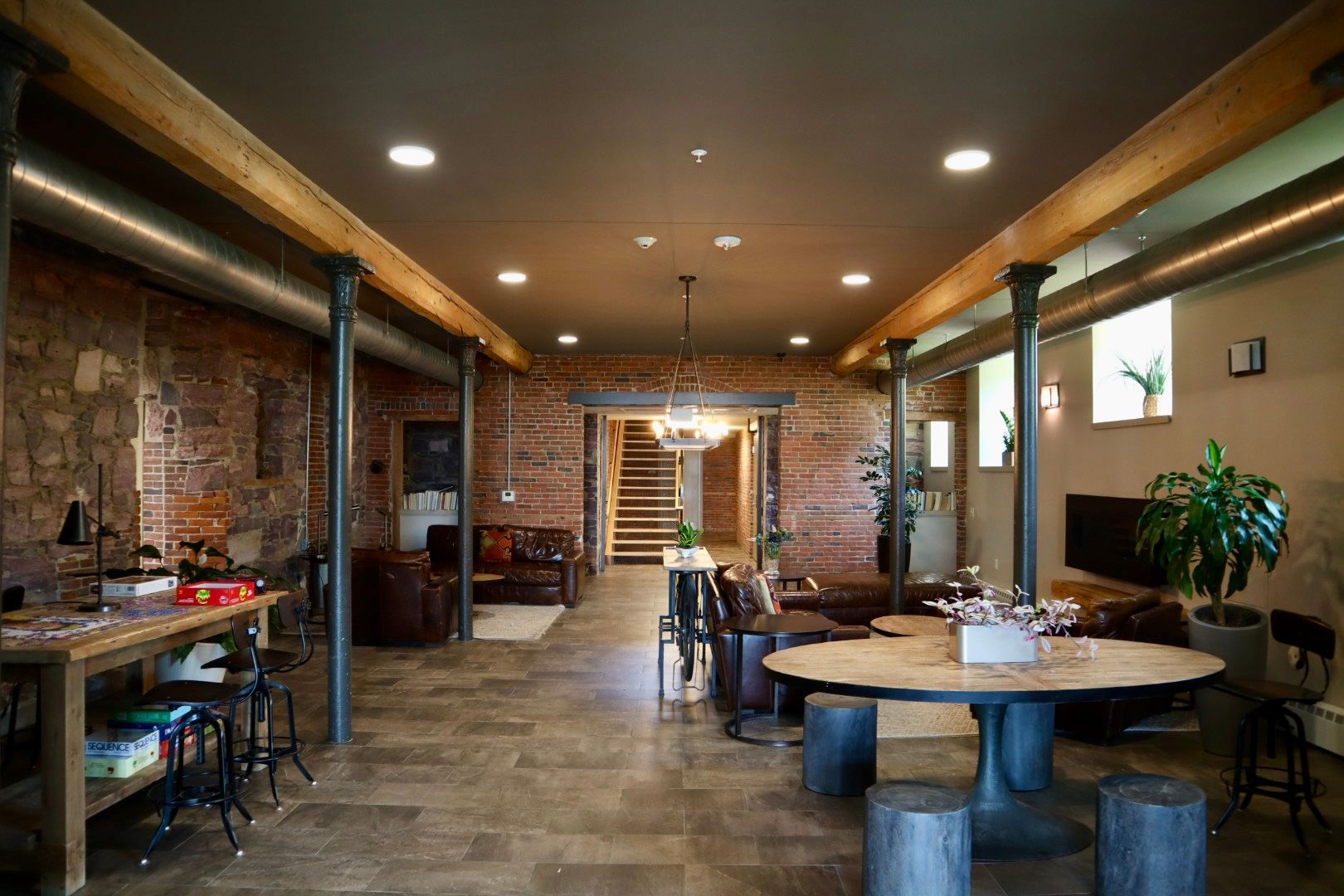 A large room with a table and chairs in it.