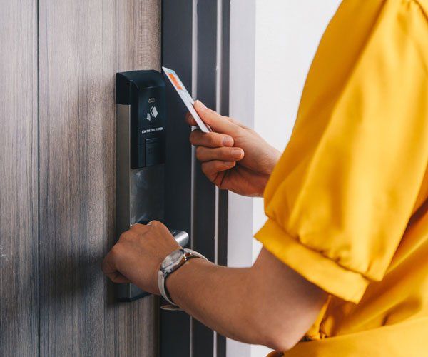 Woman Opening Digital Door Lock — Boston Rd Bronx, NY — Oasis Motel