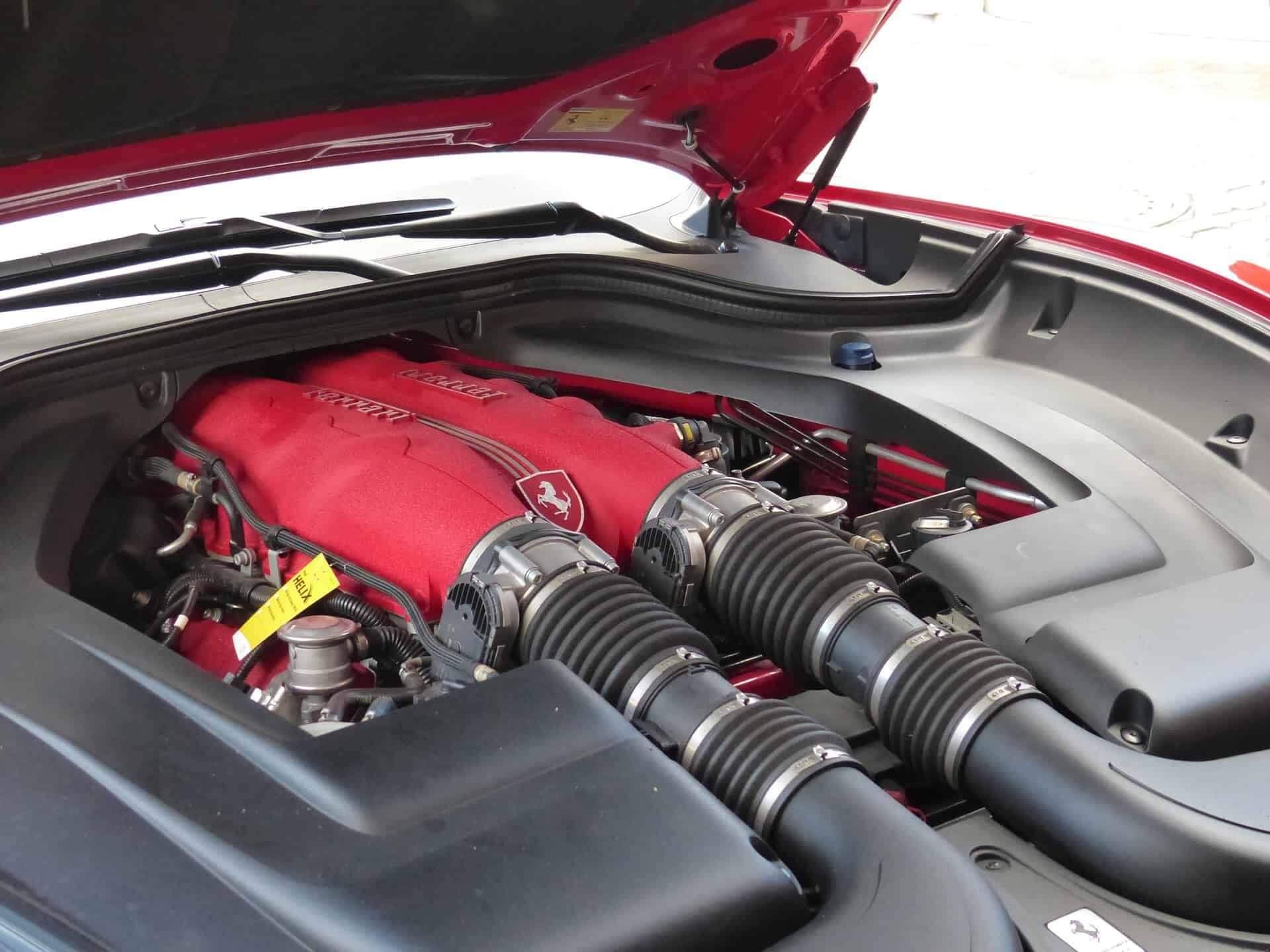 A close up of a car engine with the hood up | Doctor of Motors