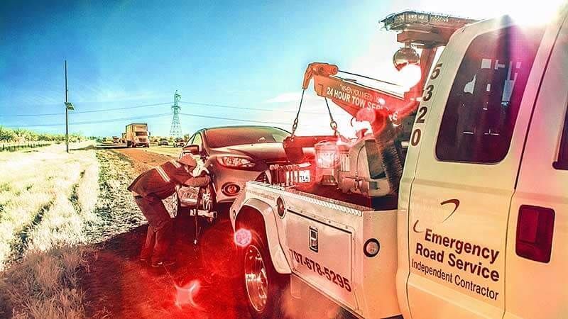 A tow truck is towing a car on the side of the road | Doctor of Motors