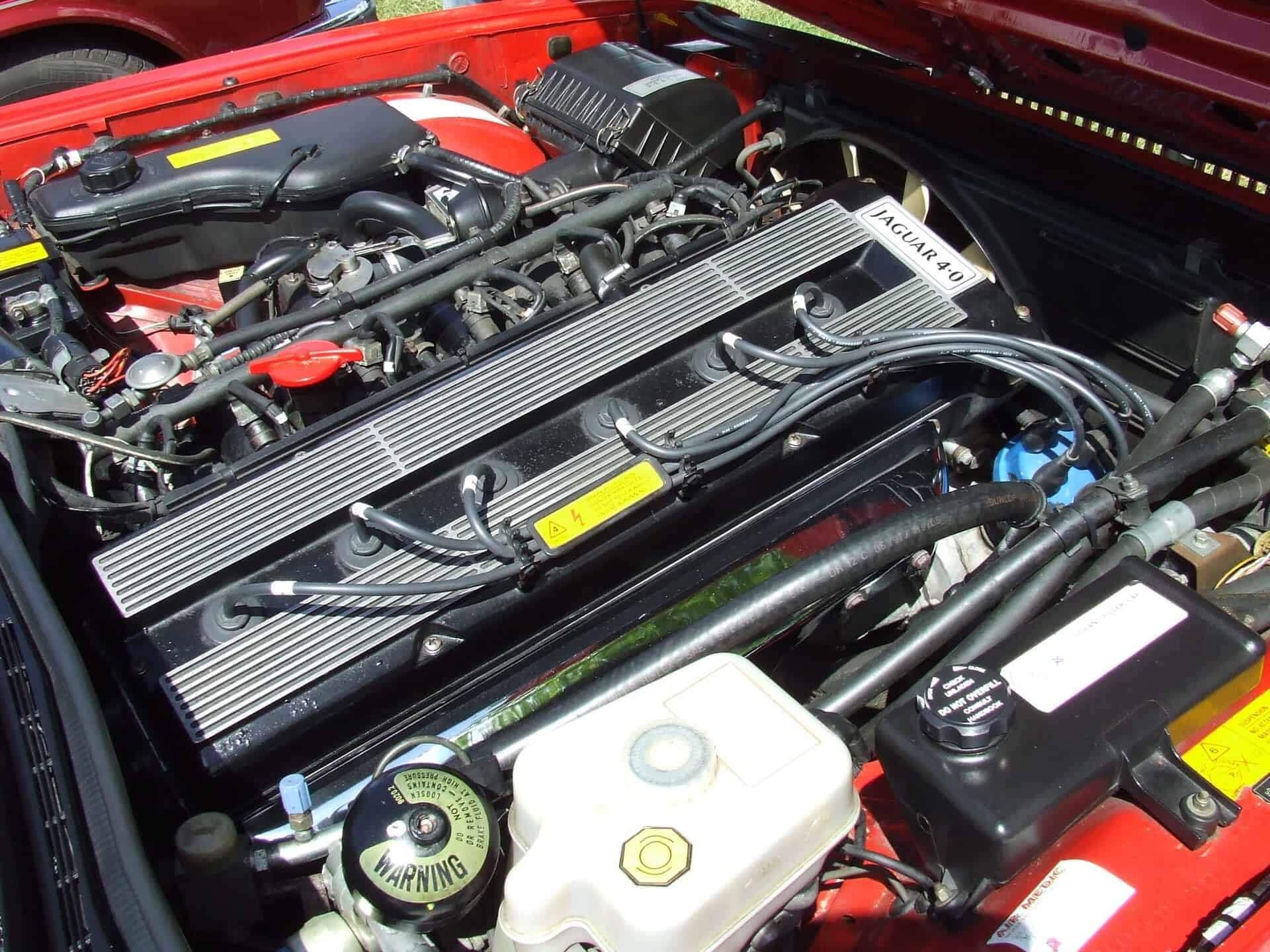 A close up of the engine of a red car | Doctor of Motors