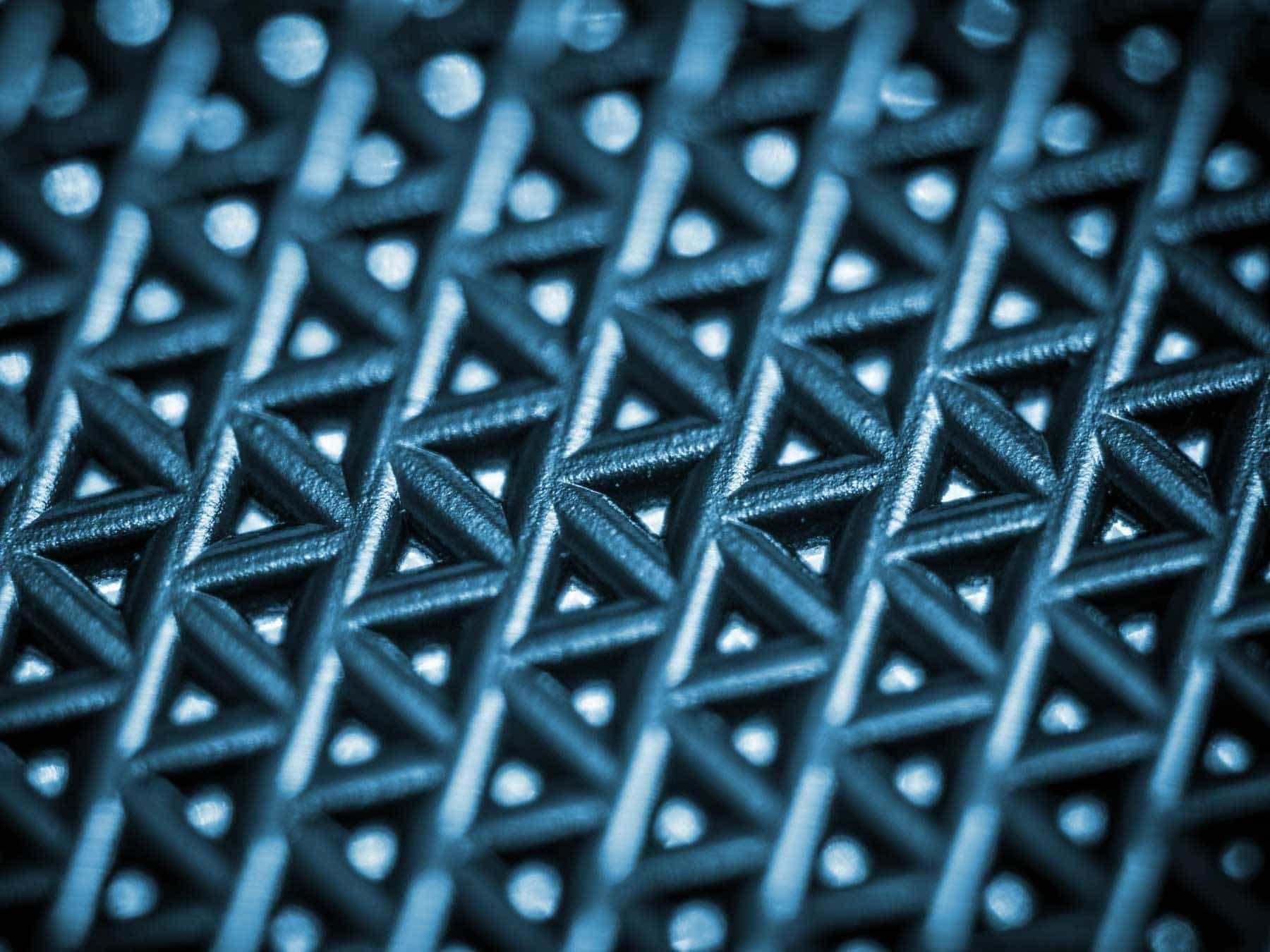 A close up of a blue and white geometric pattern on a metal surface | Doctor of Motors