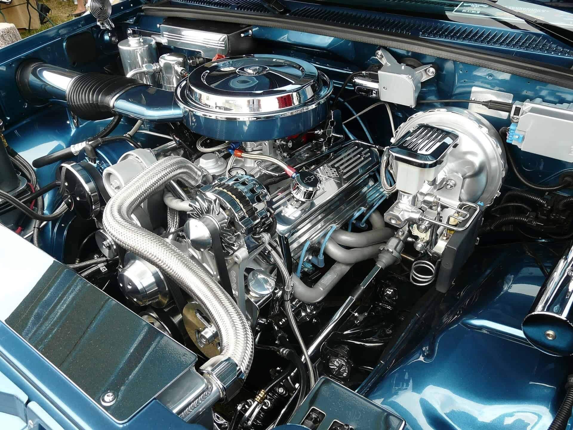 A close up of a blue car engine with a chrome air filter | Doctor of Motors