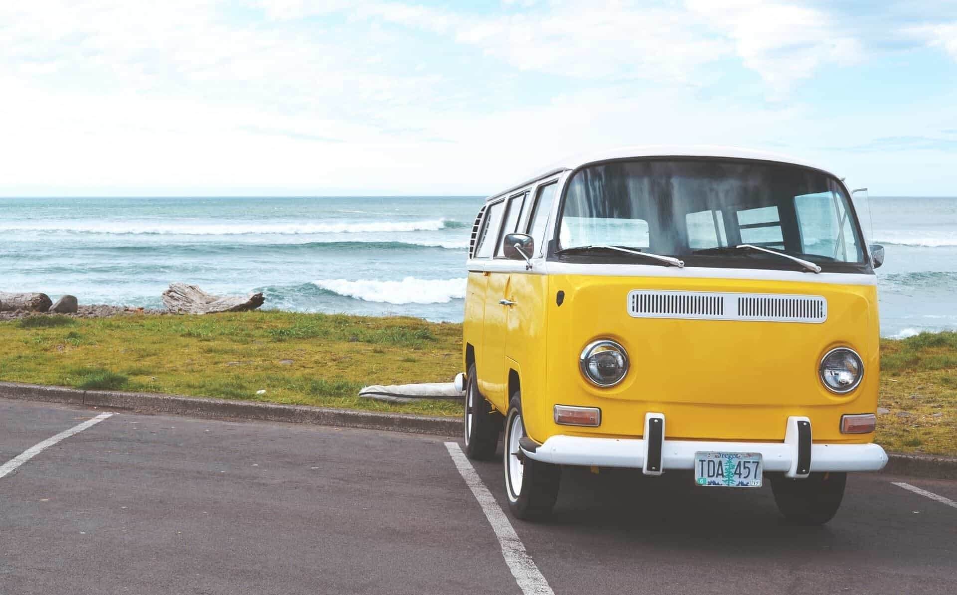 A yellow van is parked in a parking lot near the ocean | Doctor of Motors