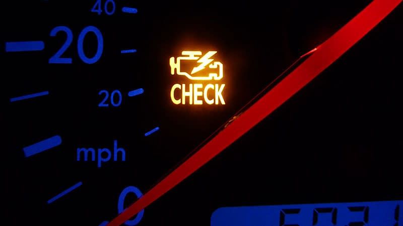 A check engine light is lit up on a dashboard | Doctor of Motors