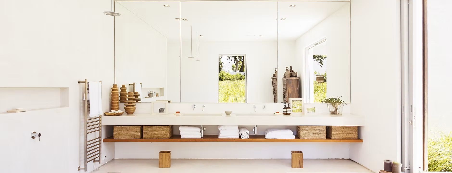 A bathroom with two sinks and a large mirror.