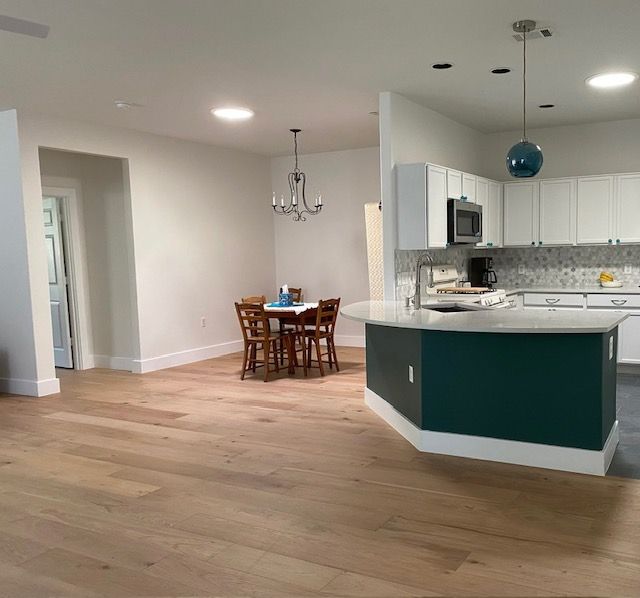 A kitchen with a table and chairs in it