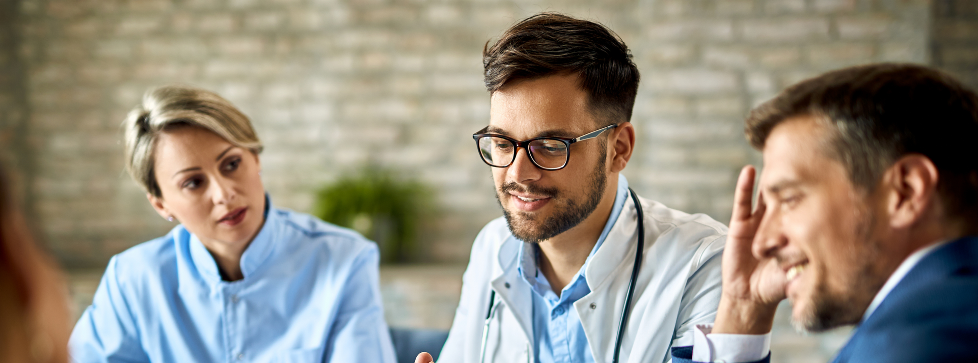 Three individuals, including a doctor, discuss digital health interventions