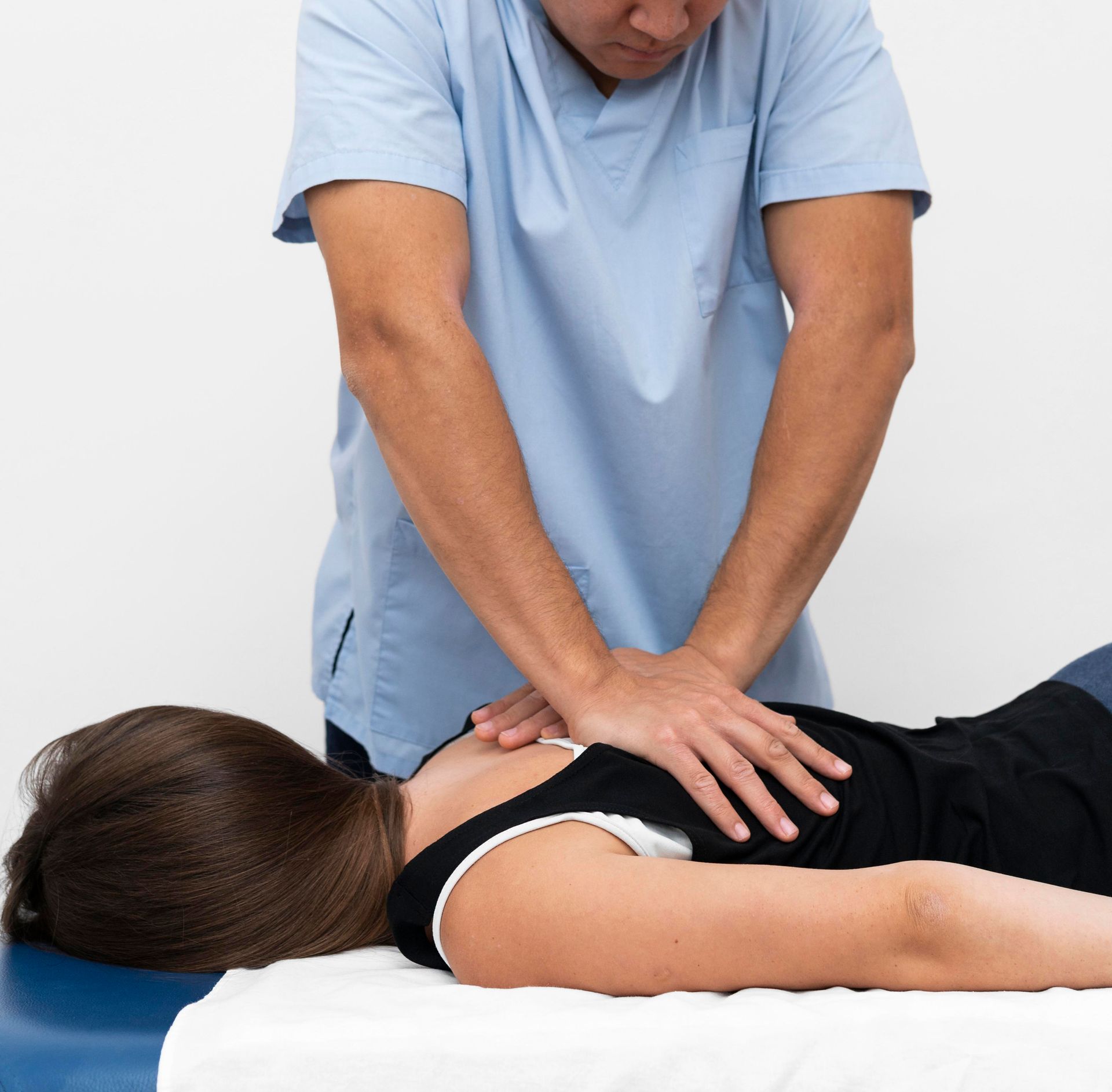 A man is giving a woman a massage on a table