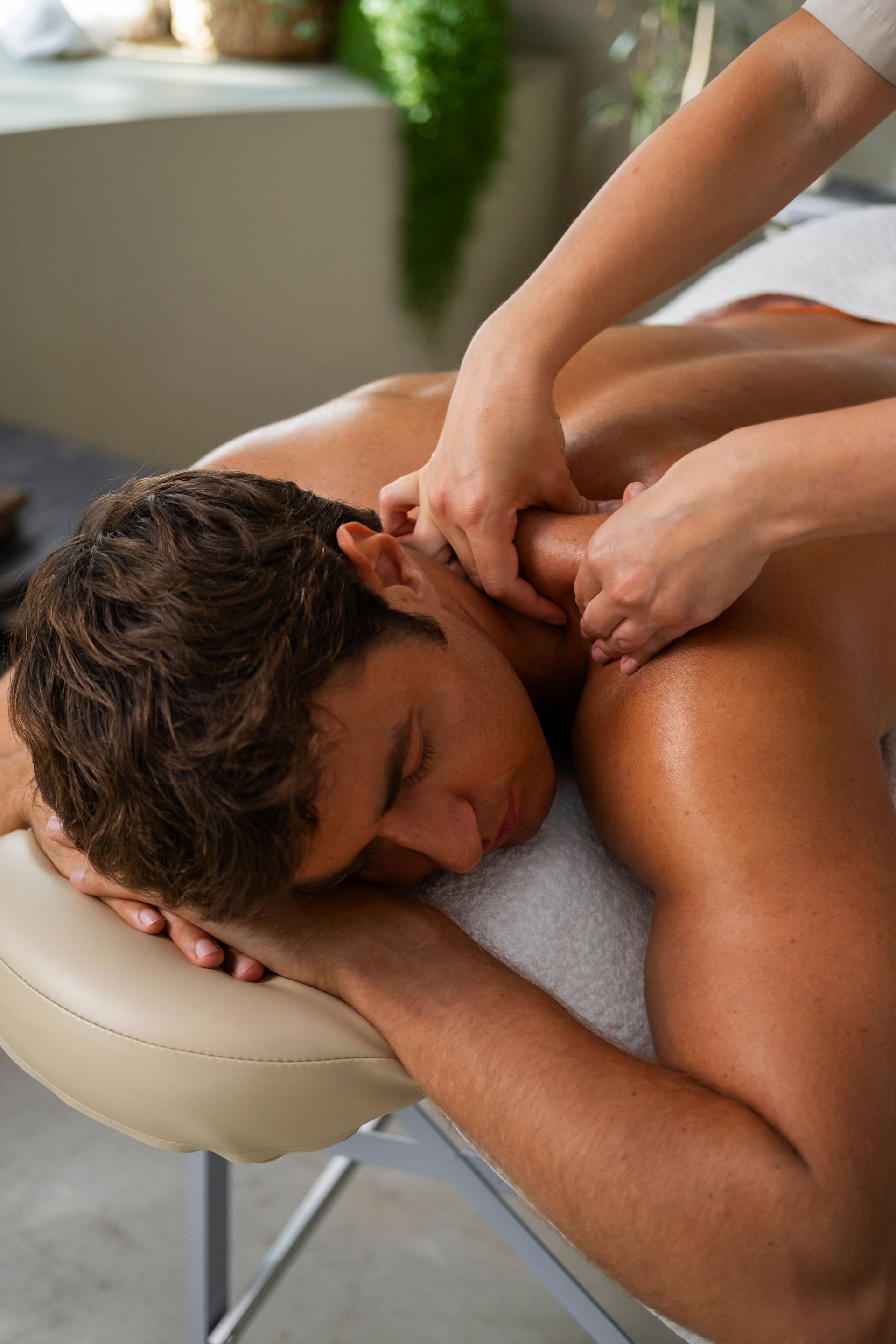 A man is laying on a massage table getting a massage.