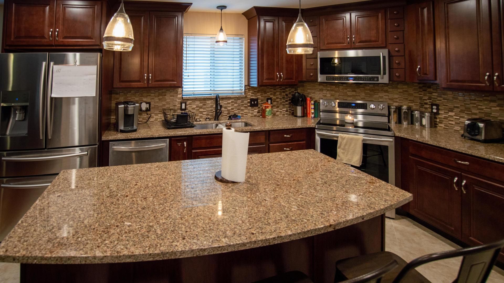 A kitchen with granite counter tops and stainless steel appliances