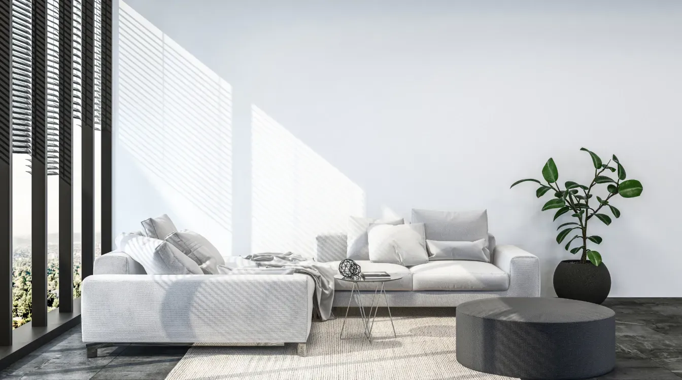 A living room with a couch , table , and potted plant.