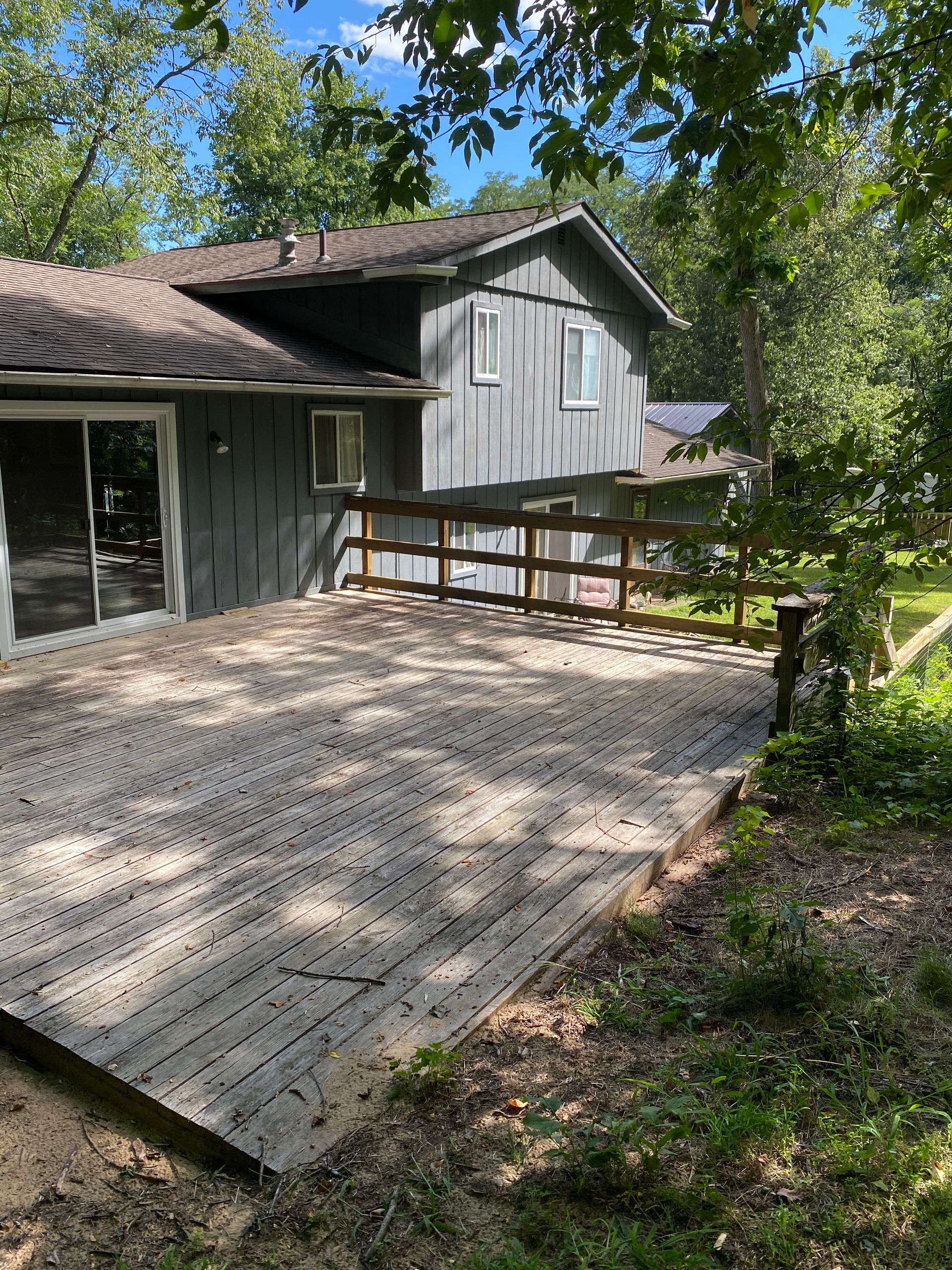 A large house with a large deck in front of it.