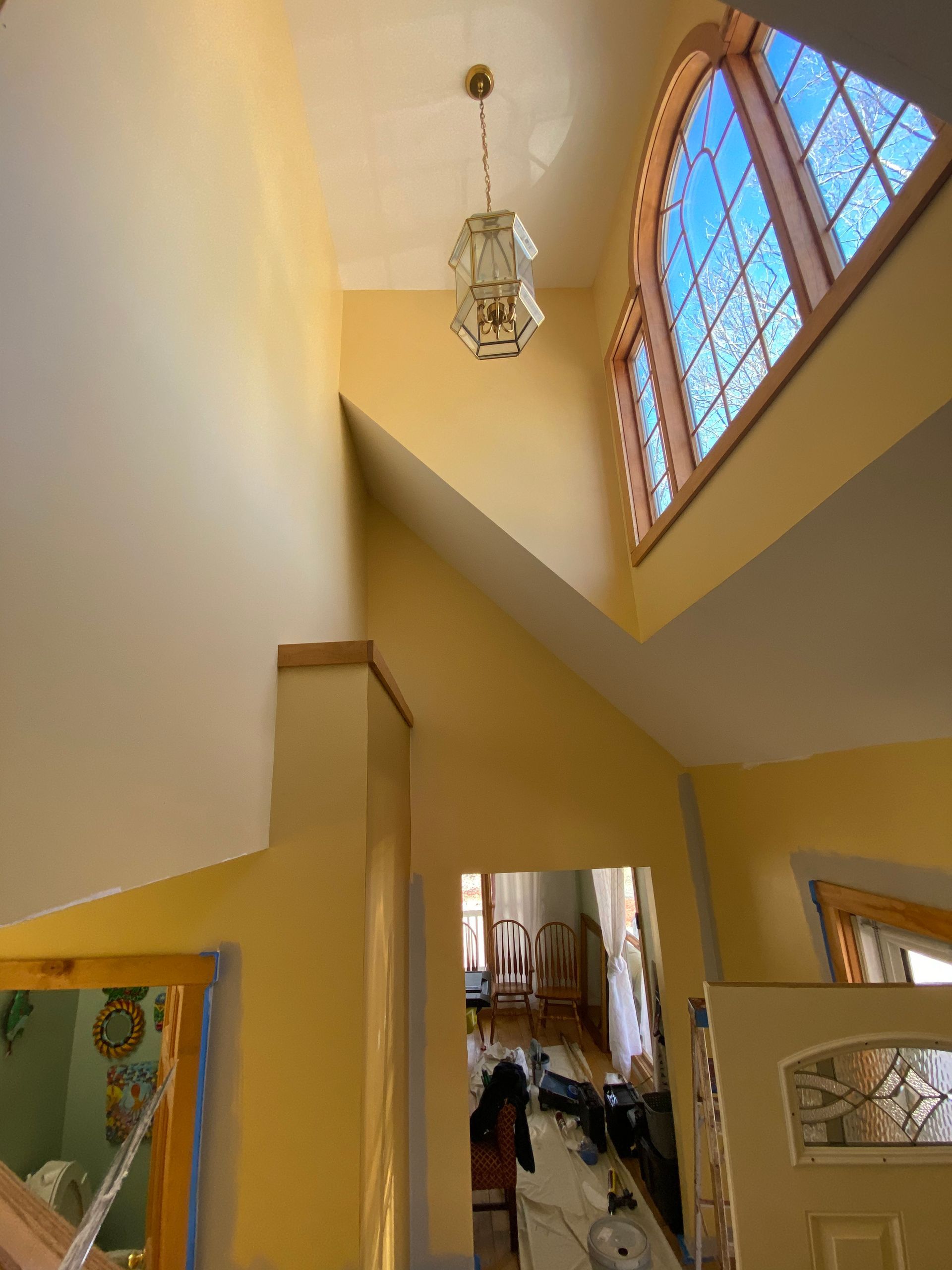 A room with a lot of windows and a chandelier hanging from the ceiling.