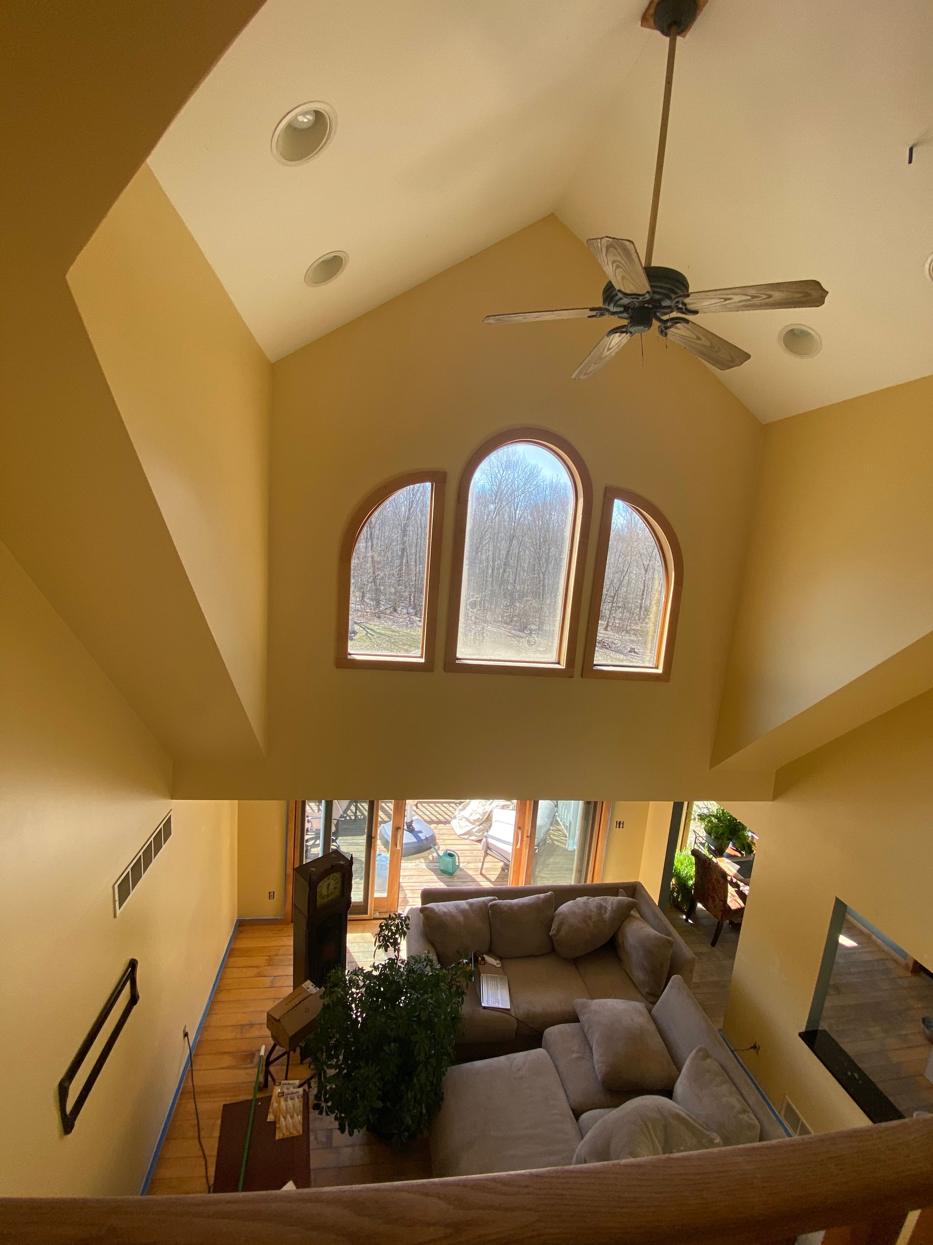 A living room with a vaulted ceiling and a ceiling fan