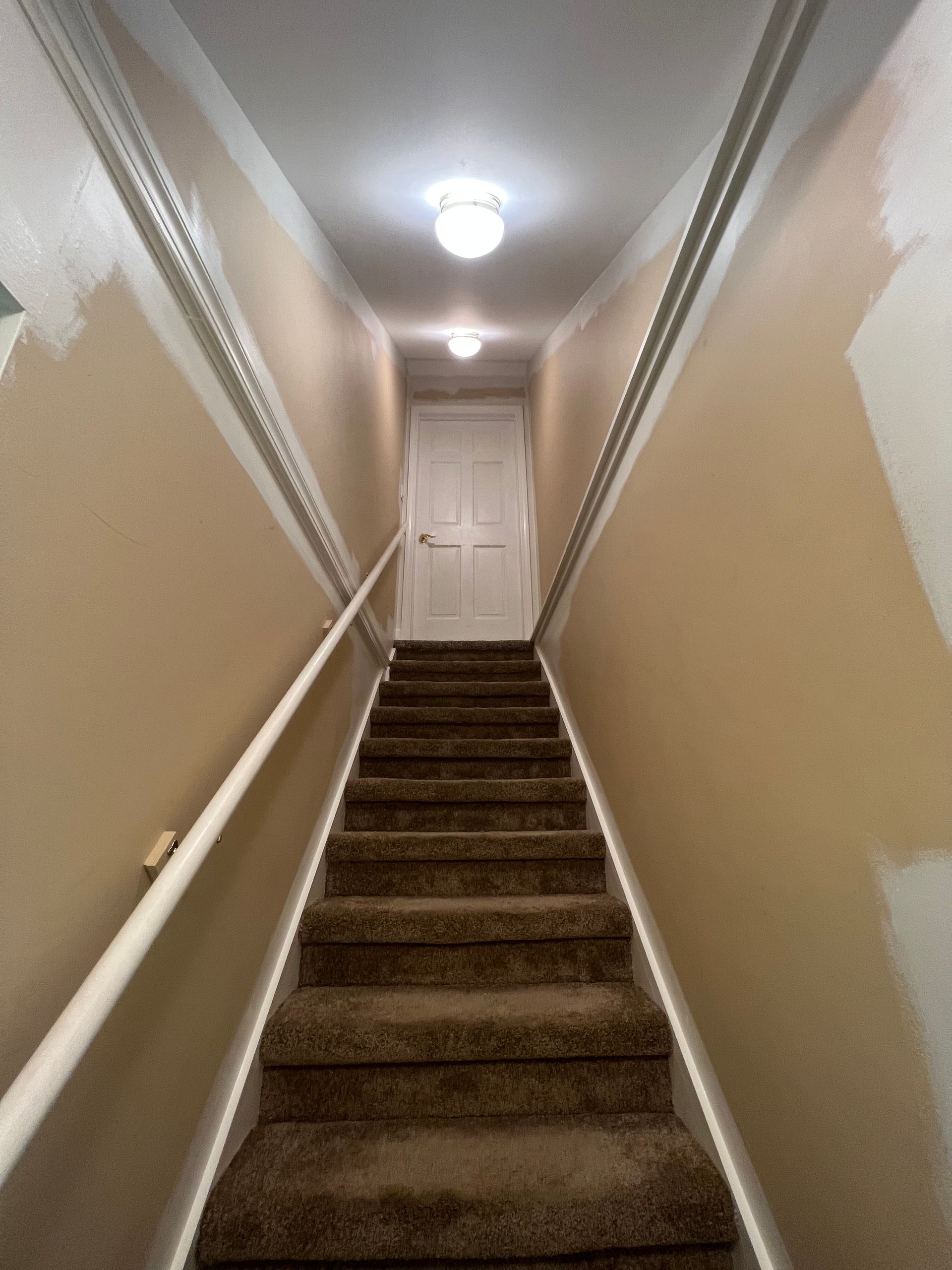 A set of stairs leading up to a door in a house.