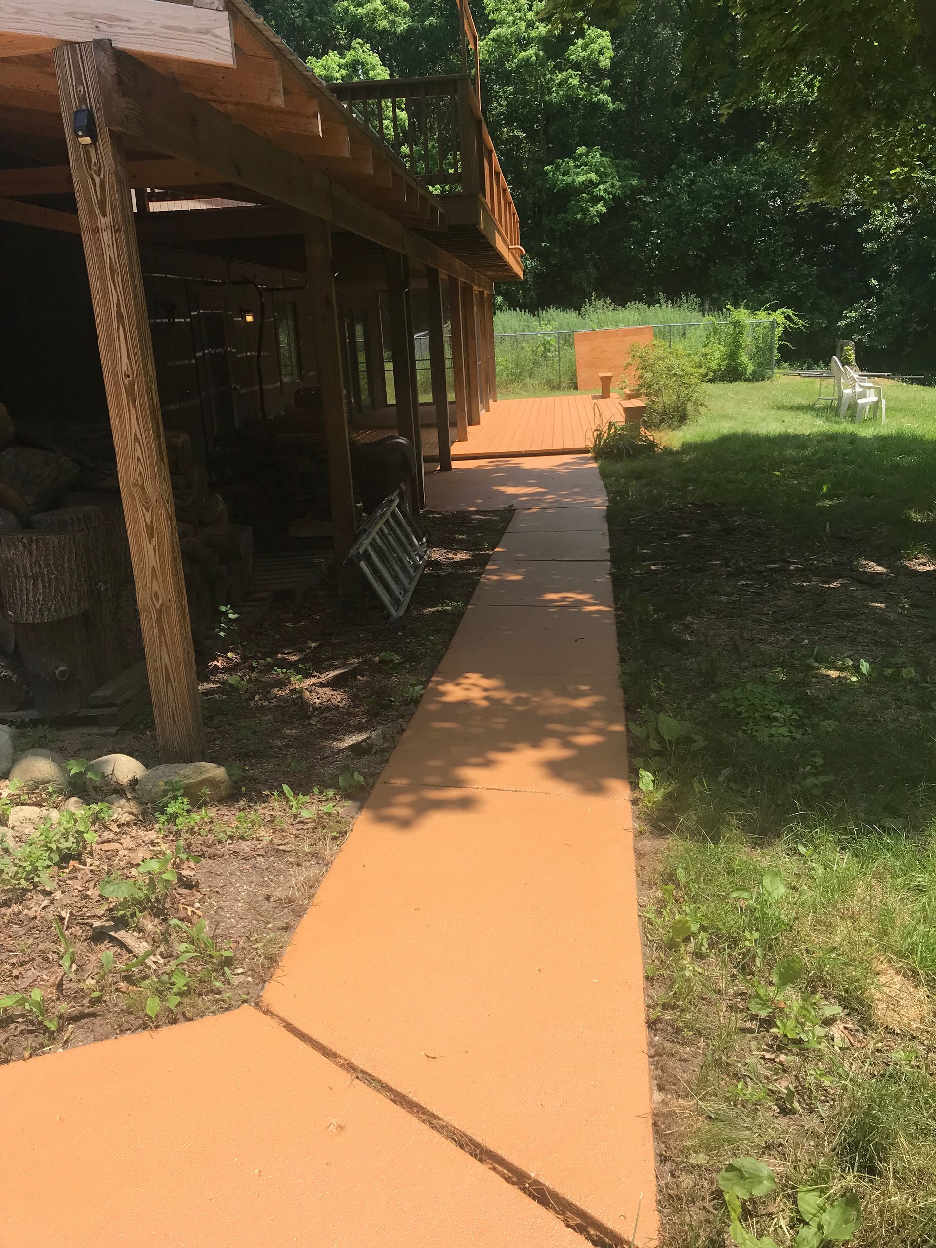 A walkway leading to a house in the woods