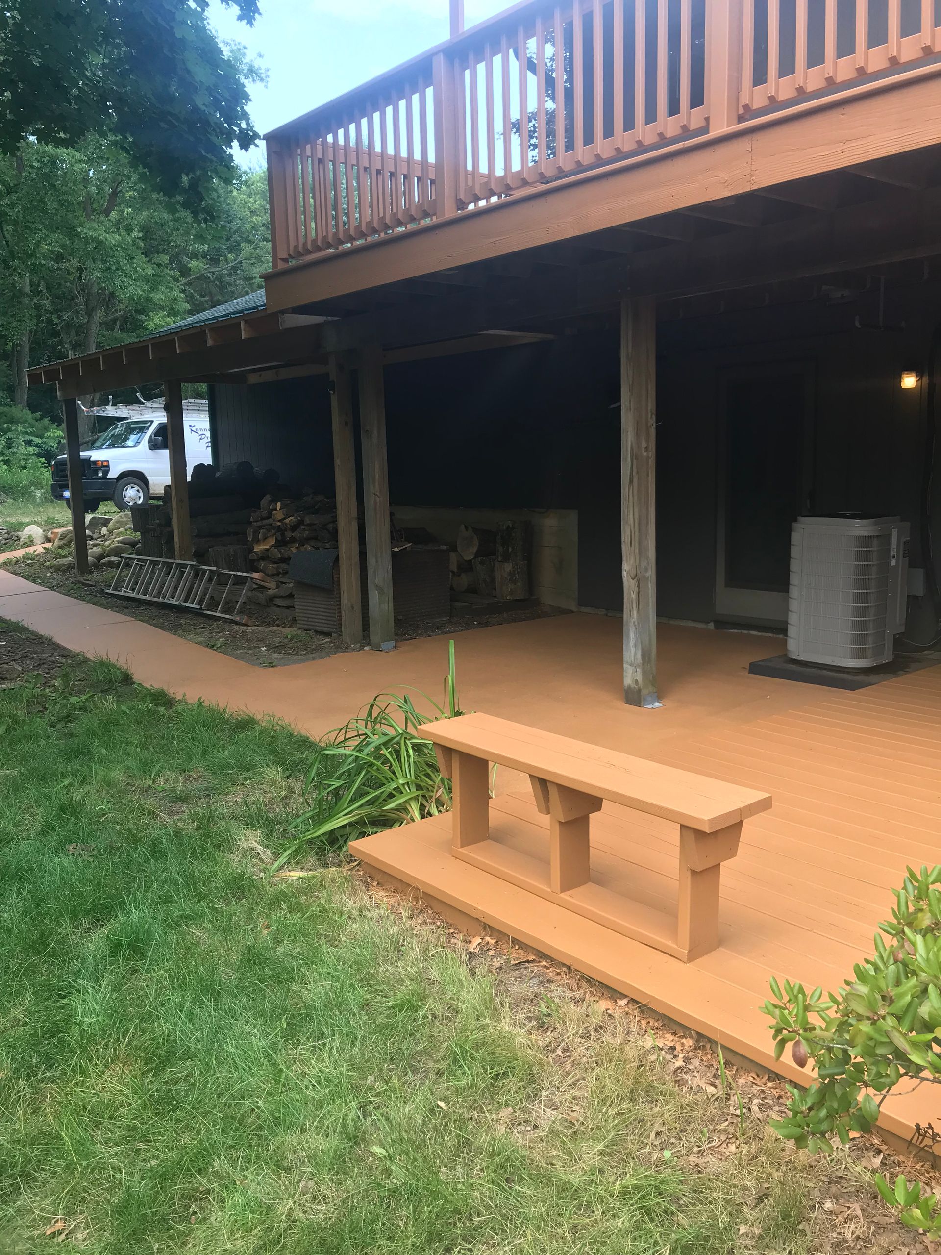 There is a bench on the side of the deck.