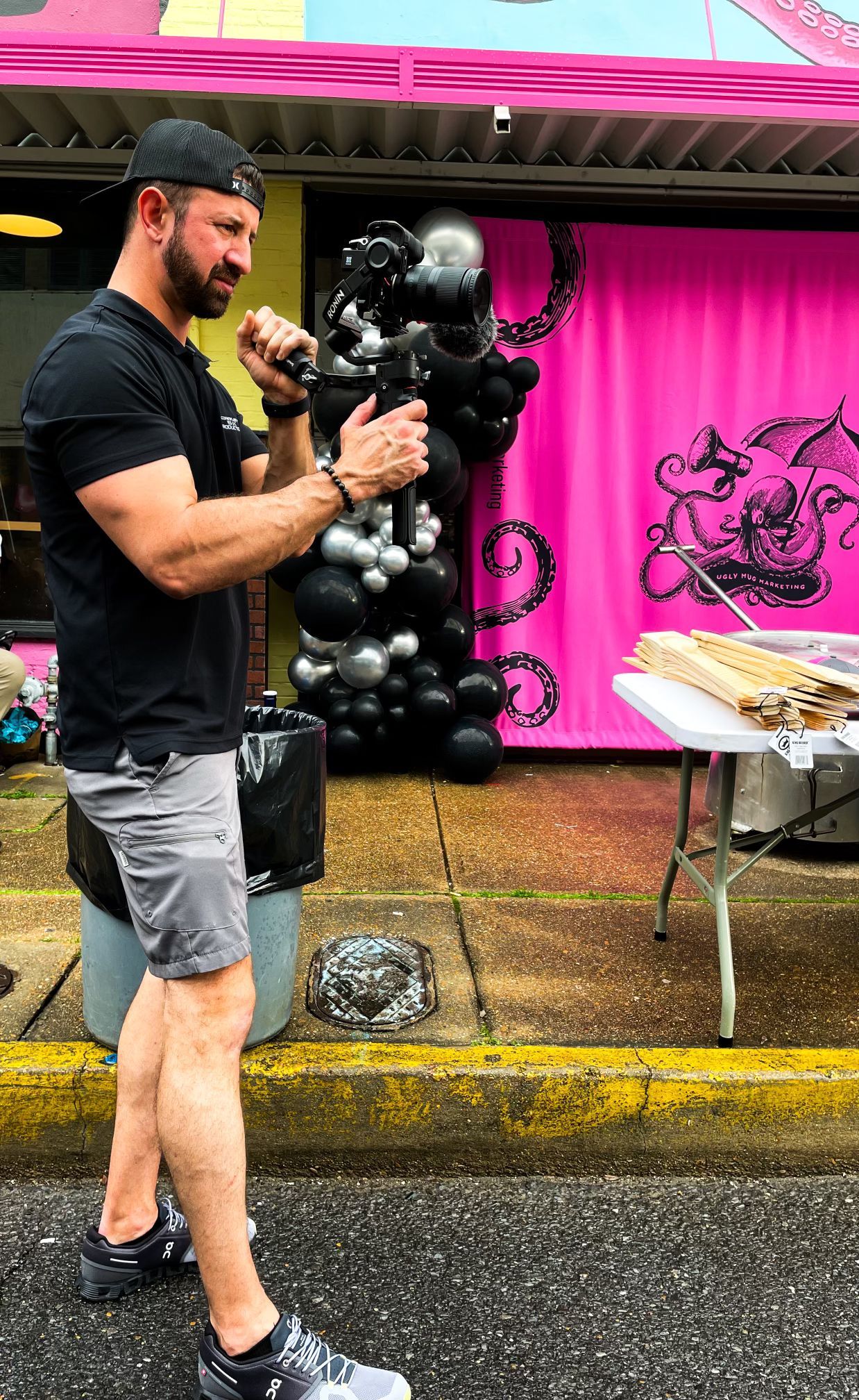 A person works at a large sound mixing console at a wedding with a Christmas tree and pyrotechnics in the background.