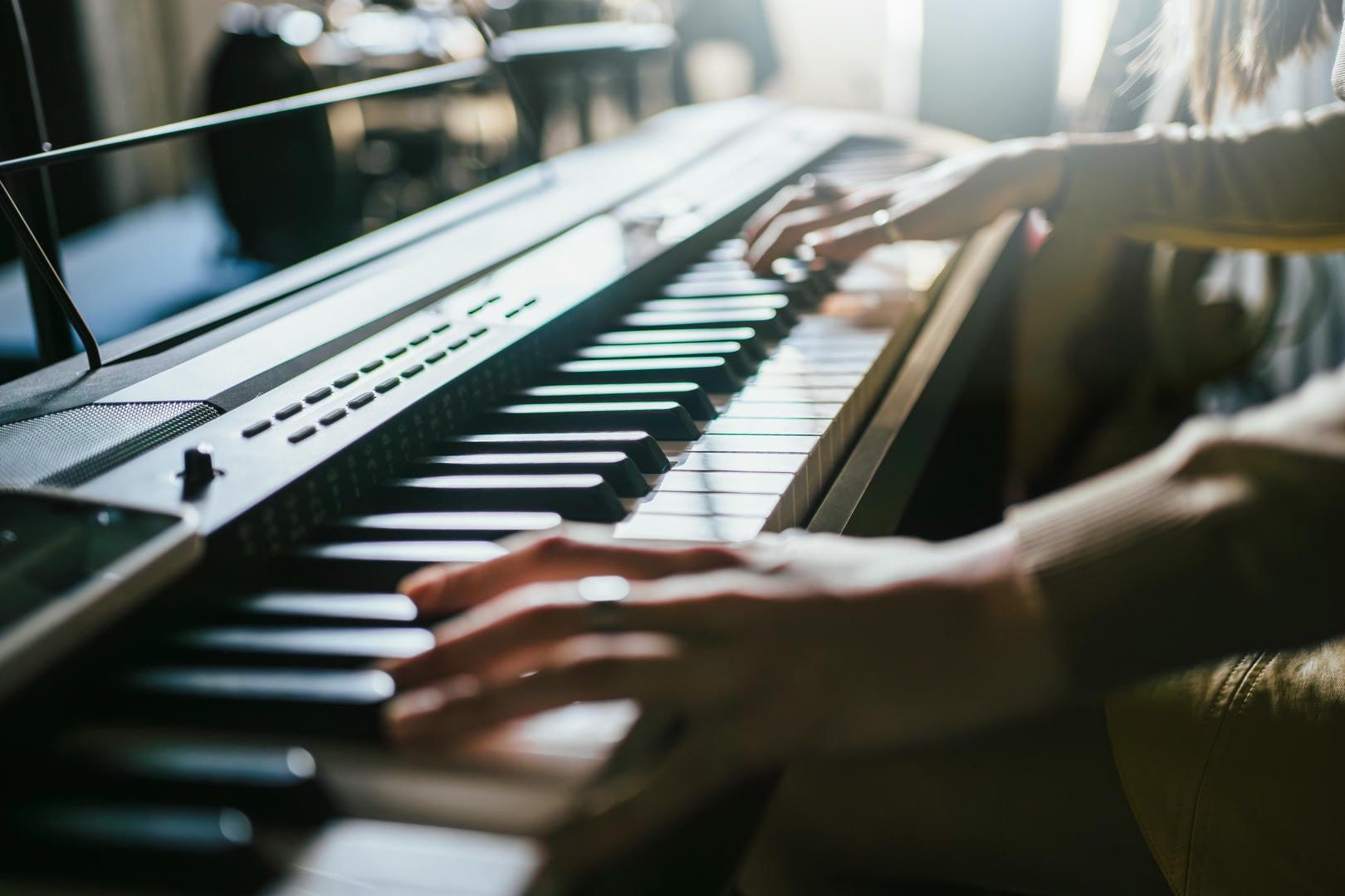 A close up of a person playing a piano.