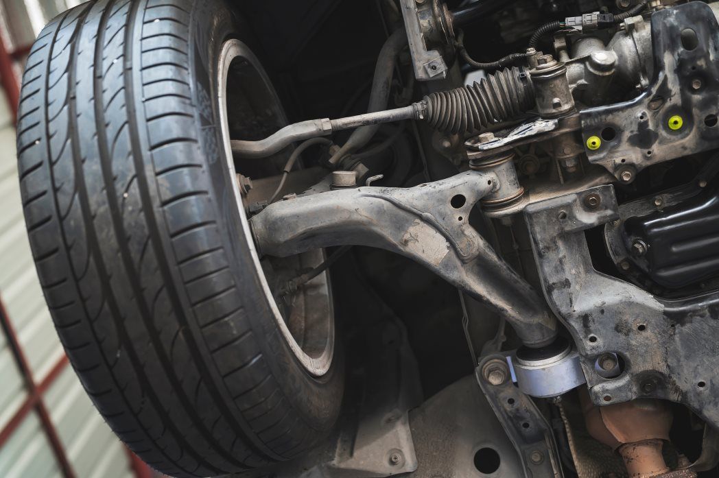A Close Up of the Underside of a Car with a Tire — Coolangatta Automotive in Coolangatta, QLD