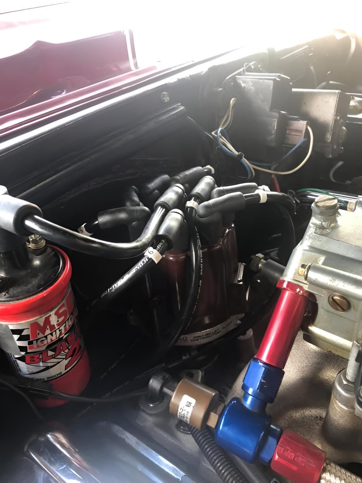 A Close Up of the Engine of a Car with a Red Coil — Coolangatta Automotive in Coolangatta, QLD