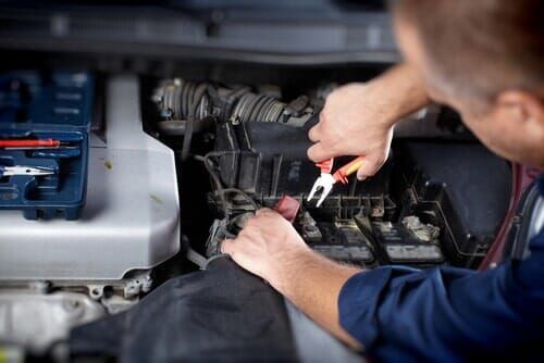 Car mechanic fixing the electrical wiring — Auto electrics and air conditioning in Garbutt QLD