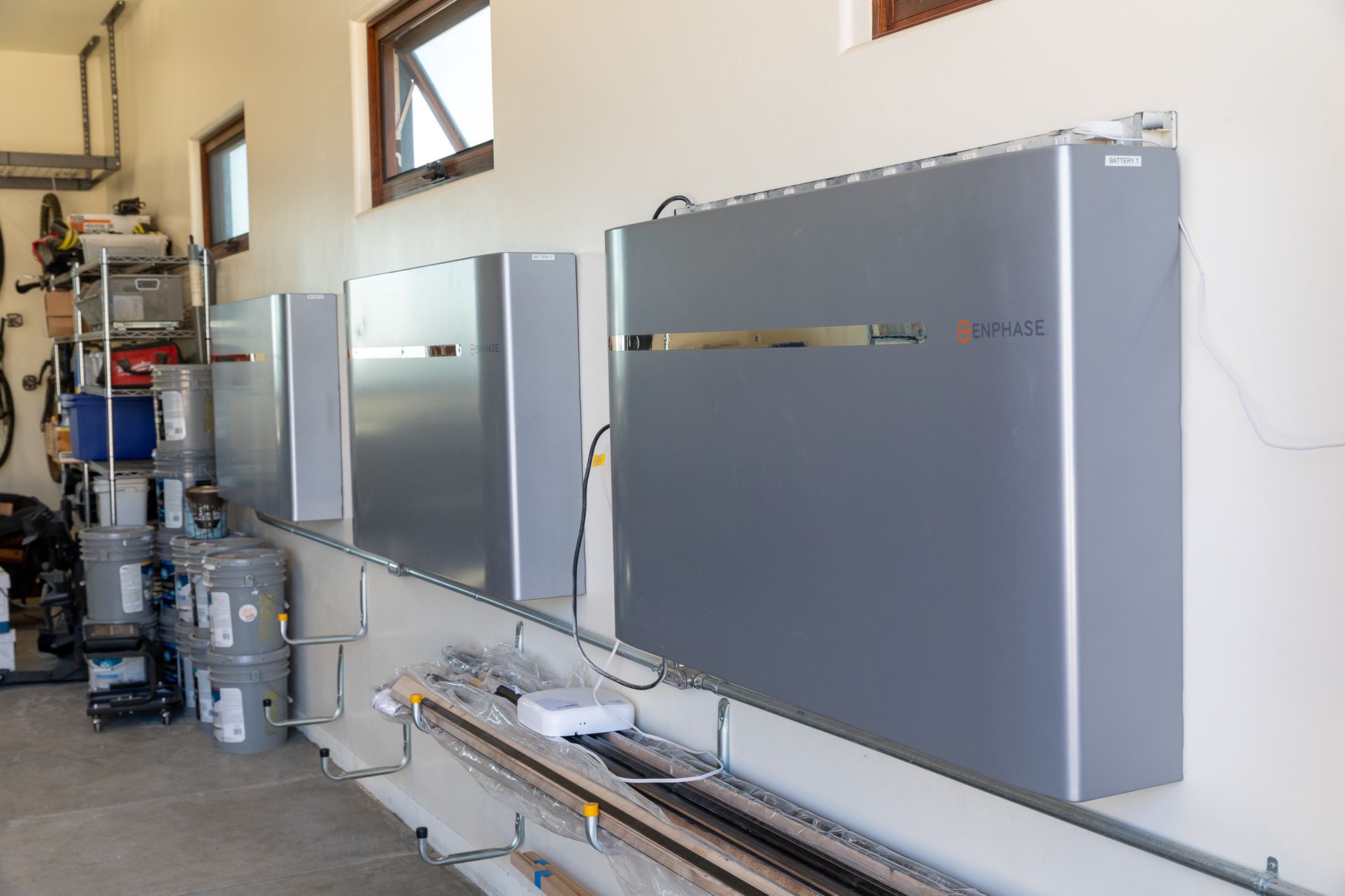 A garage with a row of gray boxes on the wall.