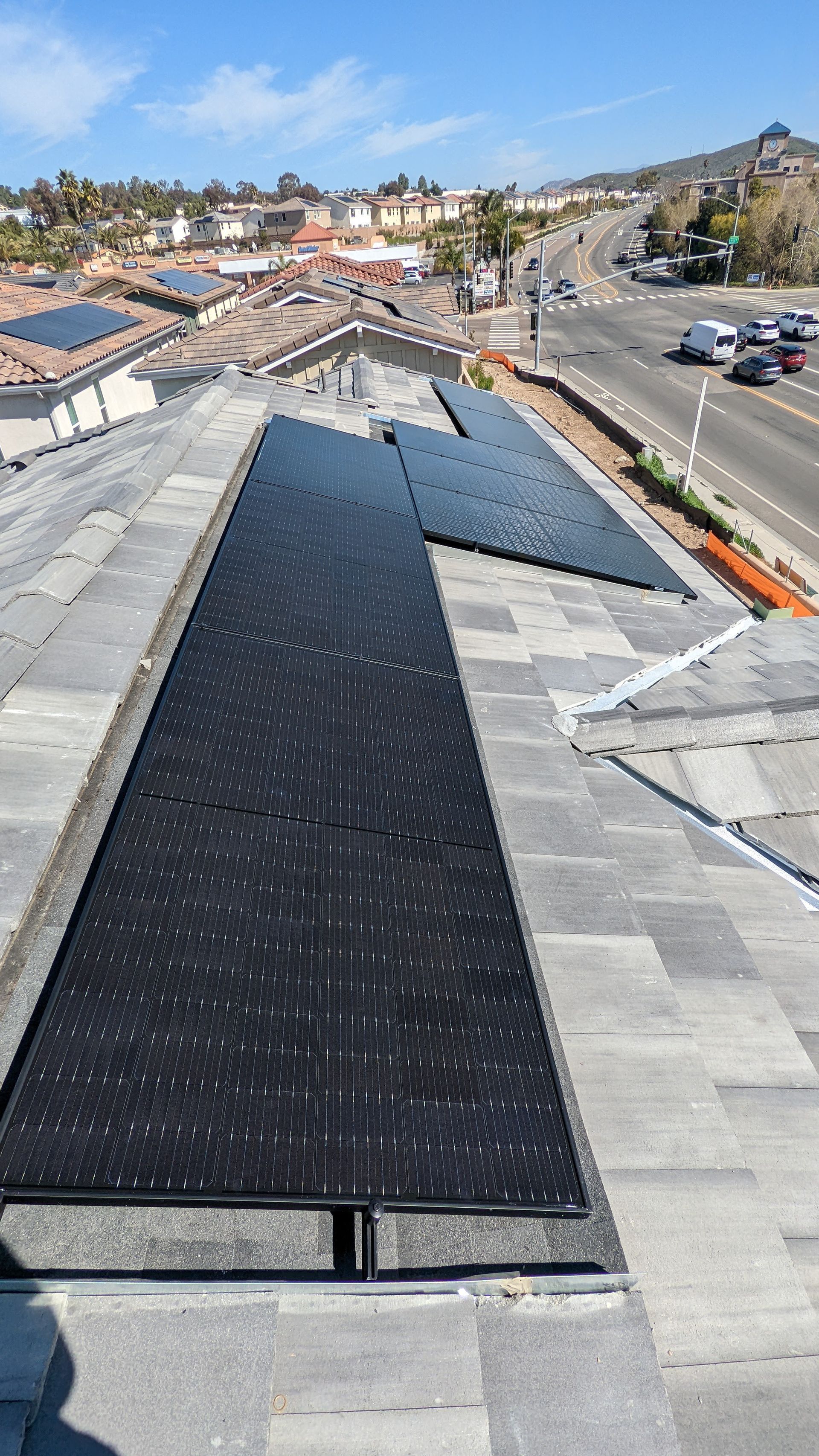 A row of solar panels on the roof of a building.