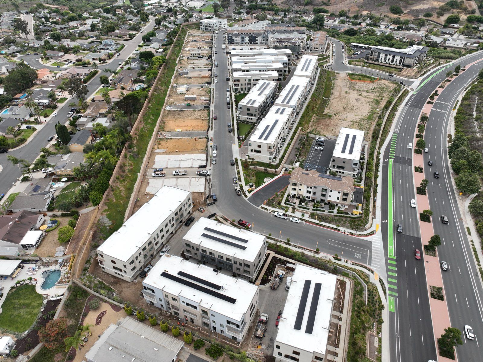 An aerial view of a residential area with lots of buildings and a highway.