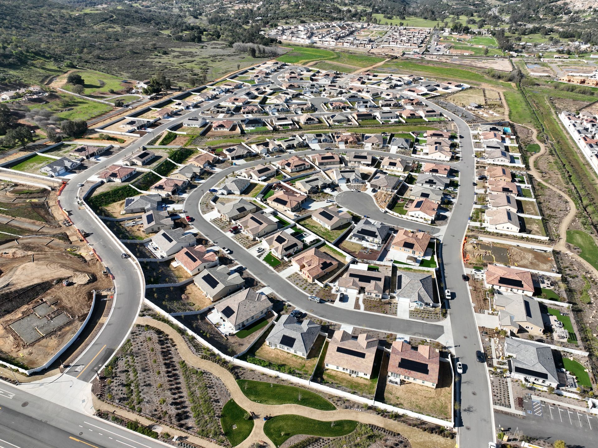 An aerial view of a residential area with lots of houses and roads