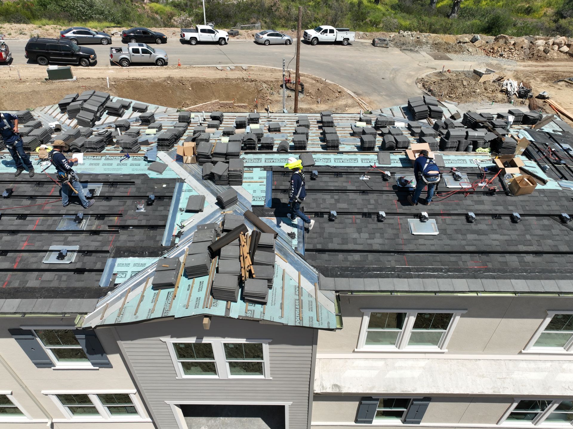 A group of people are working on the roof of a building.