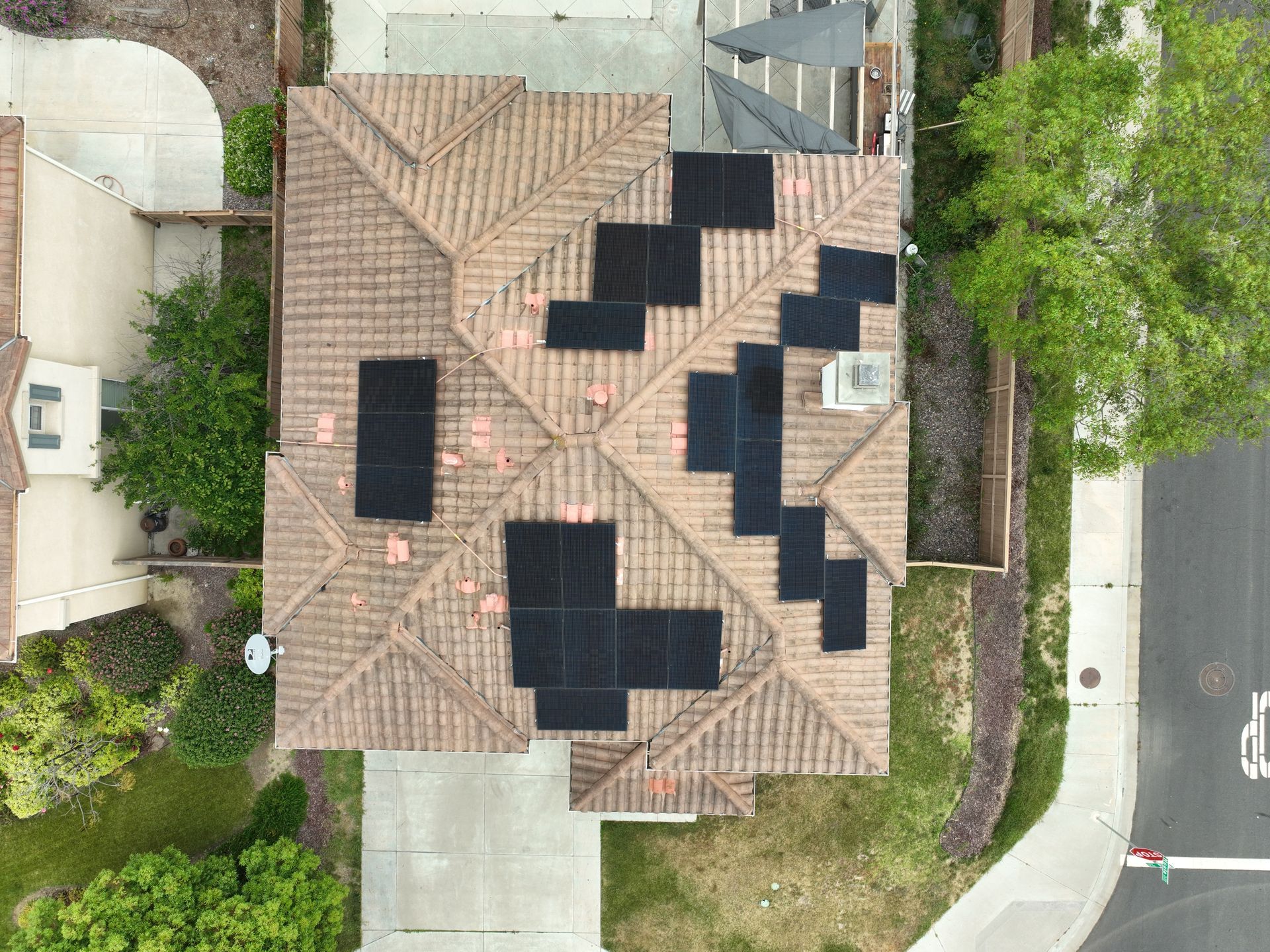 An aerial view of a house with solar panels on the roof.