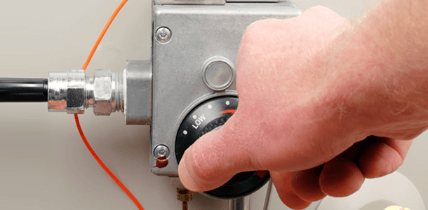 A thermostat being being turned