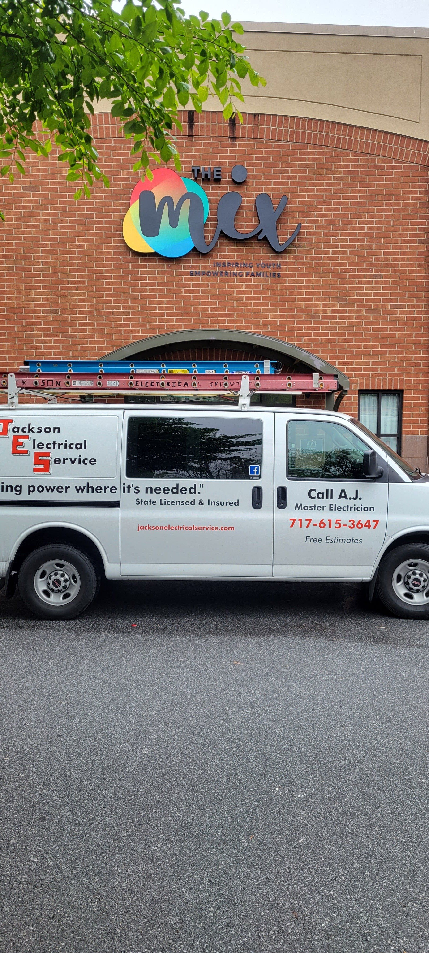 a white van is parked in front of a brick building .