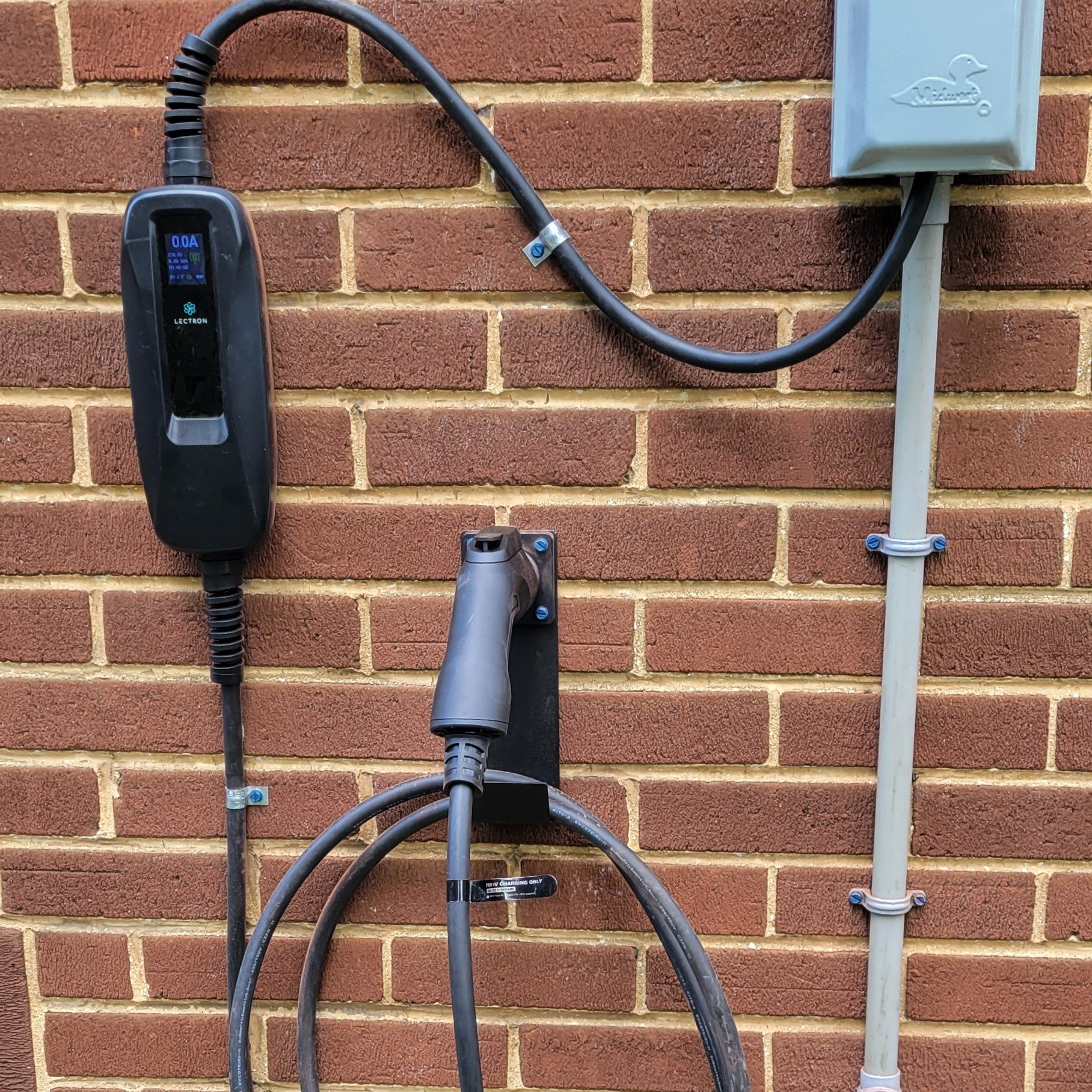 a brick wall with a charger attached to it