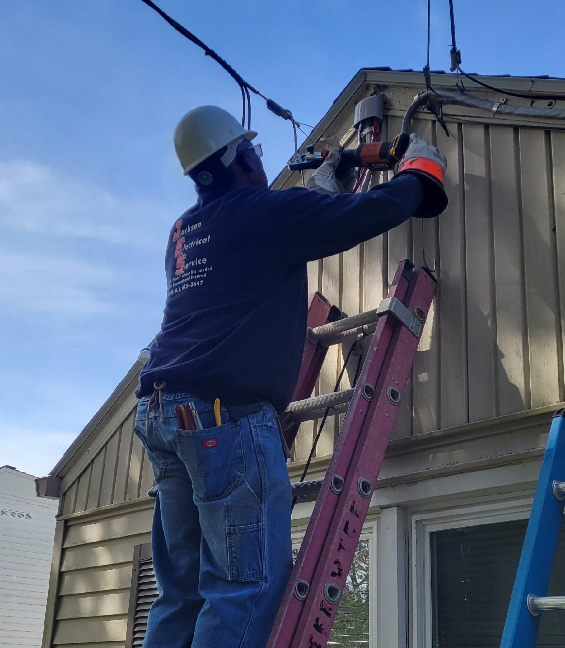 a man is standing on a ladder working on a house